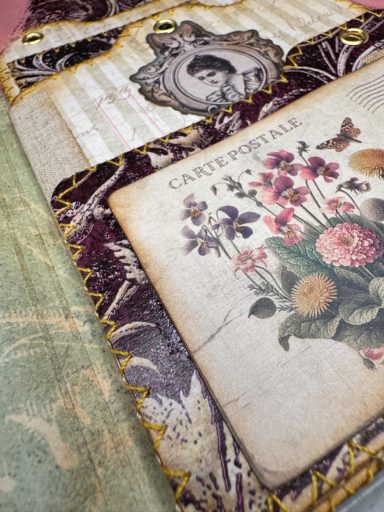 Handmade junk journal page with vintage floral book illustration and ornate border, Golden Spine Studio.