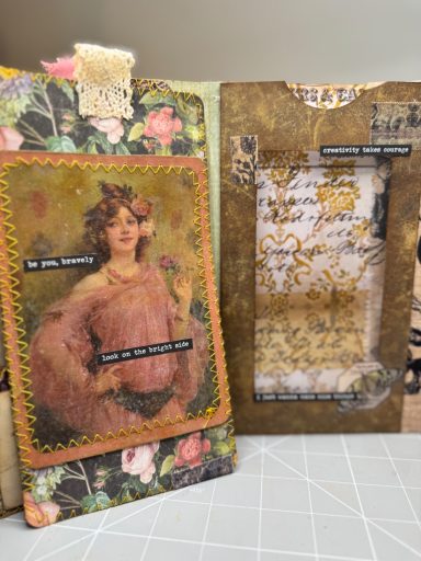 Handmade junk journal spread with vintage female portrait, floral collage and stitched details, Golden Spine Studio.